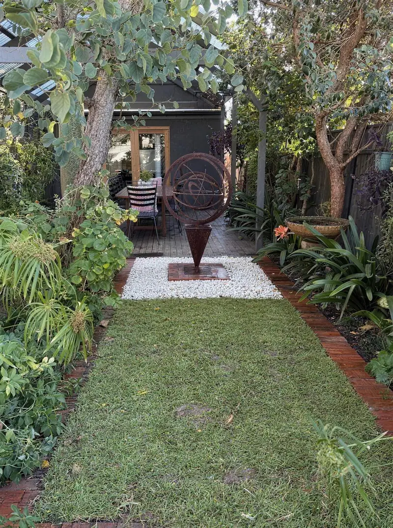 New roll-on lawn laid by Garden Grit between garden beds at a Norwood, Adelaide property